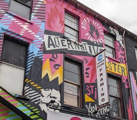 The legacy of the "Godfather of Belfast punk", Terri Hooley, has been celebrated with a new mural in the heart of his native city.